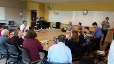 Educators sitting around a conference table